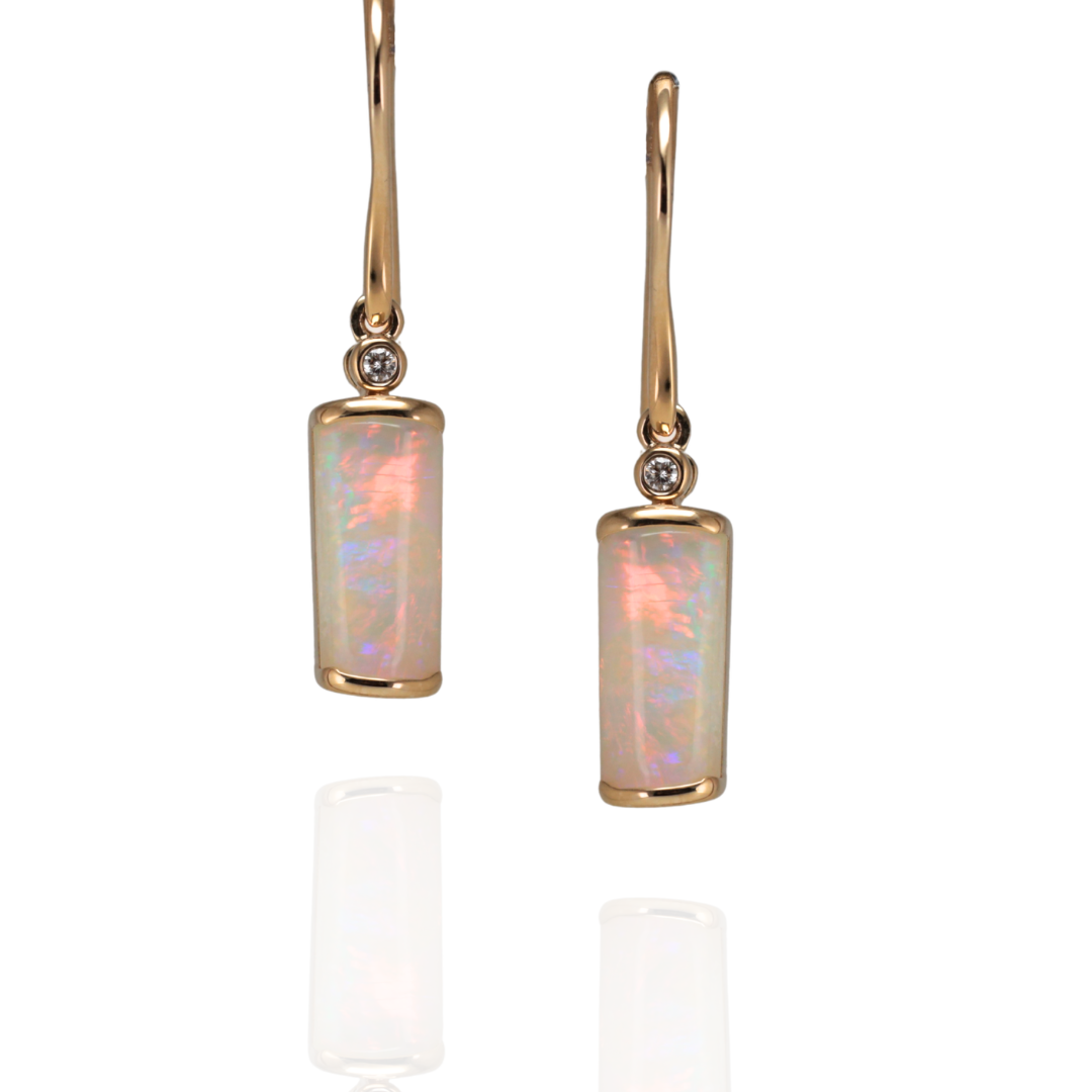 Belemnite opal dangle earring set in  yellow gold with diamond on a white background