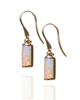 Gold earrings with opal stones on a white background