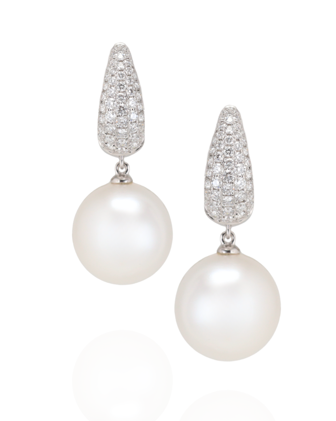 Pair of pearl earrings with diamond-studded tops on a white background