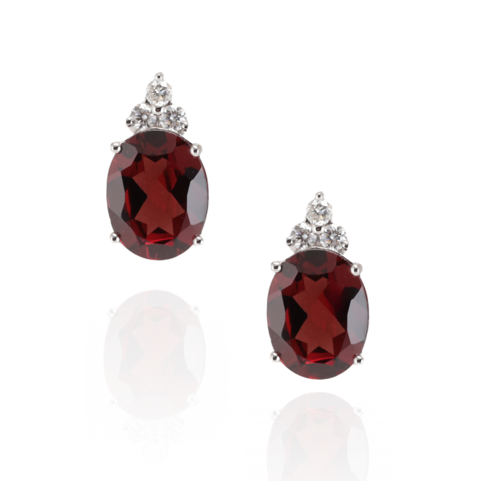 Pair of 18ct white gold earrings with a oval red Garnet gemstone with three 0.14ct diamonds north of the garnet, with butterfly backs on a white background. handcrafted in the heart of Sydney, Zappacosta Jewels 