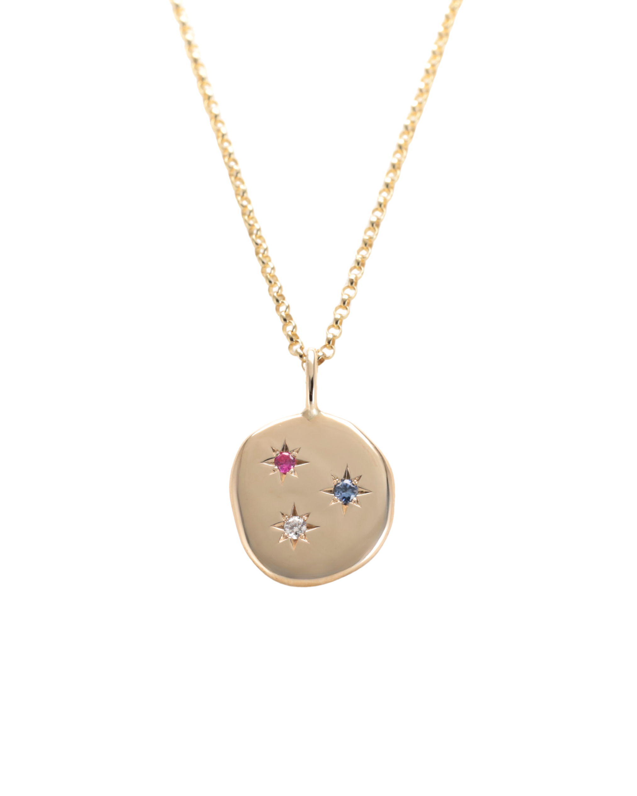 A gold pendant necklace featuring an irregular, organic-shaped gold disc pendant with three small star-shaped gemstone accents in pink, blue, and clear, Diamond, sapphire and Ruby. suspended from a delicate gold chain against a solid white background. Handmade by Zappacosta Jewels