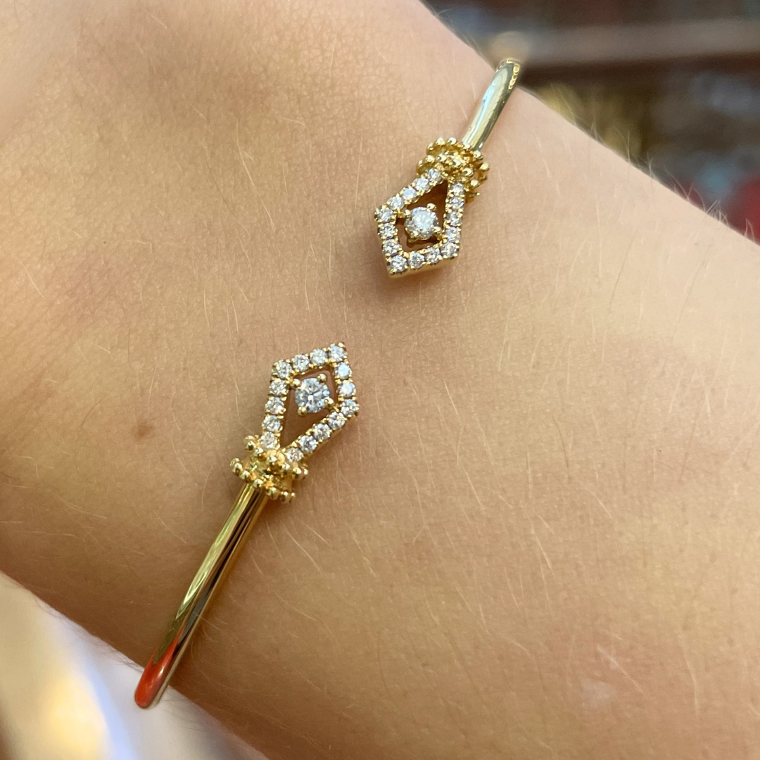 Gold bangle with diamonds on a wrist