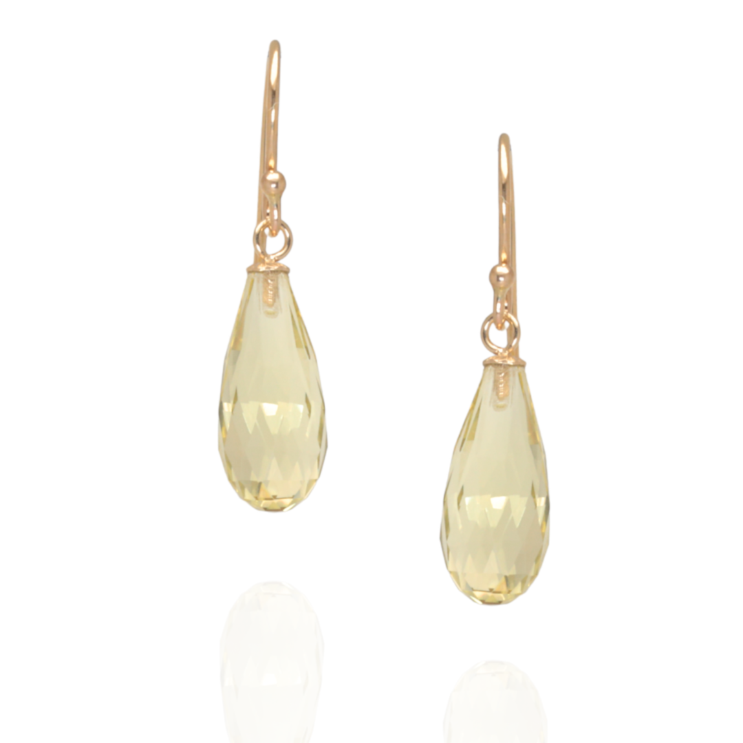 Lemon quarts hook earrings suspended in yellow gold on a white background 