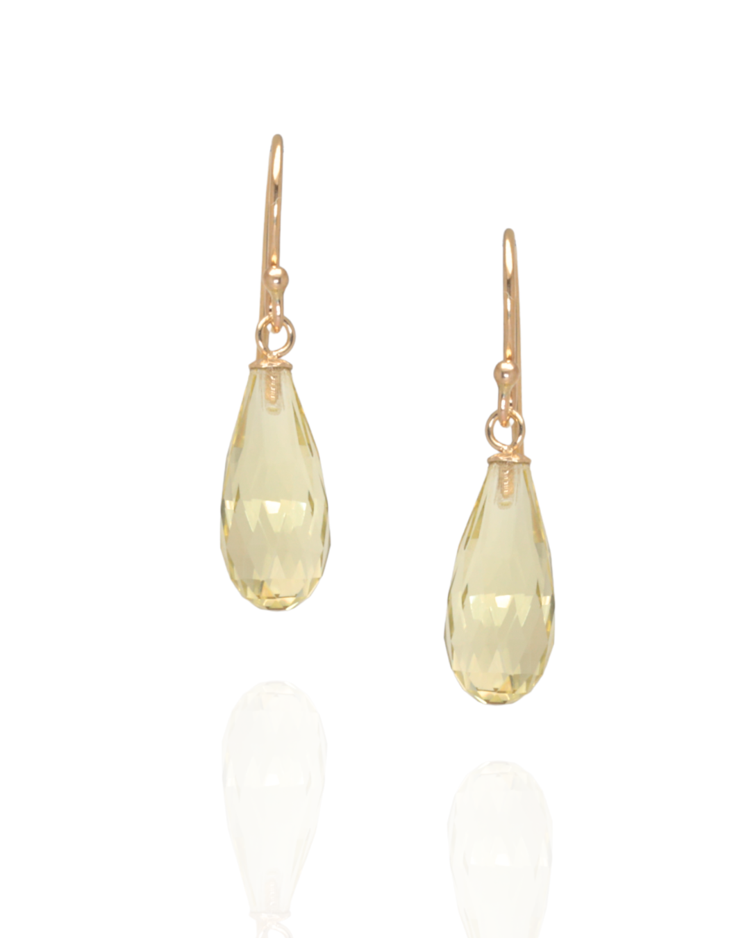 Lemon quarts hook earrings suspended in yellow gold on a white background 
