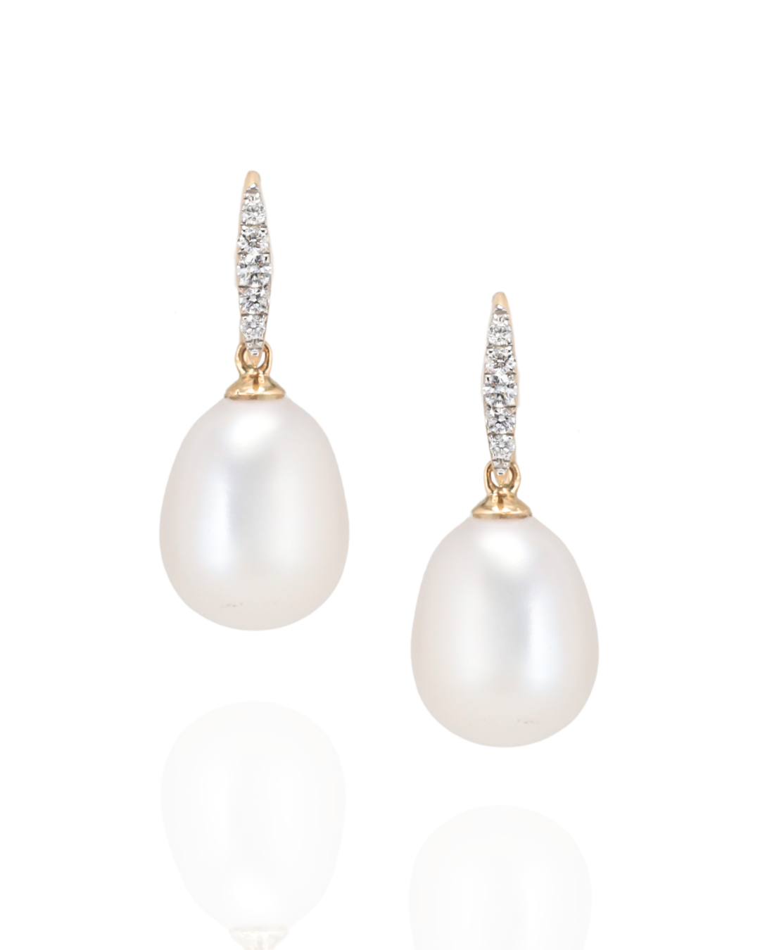 Pearl earrings with gold and diamond accents on a white background