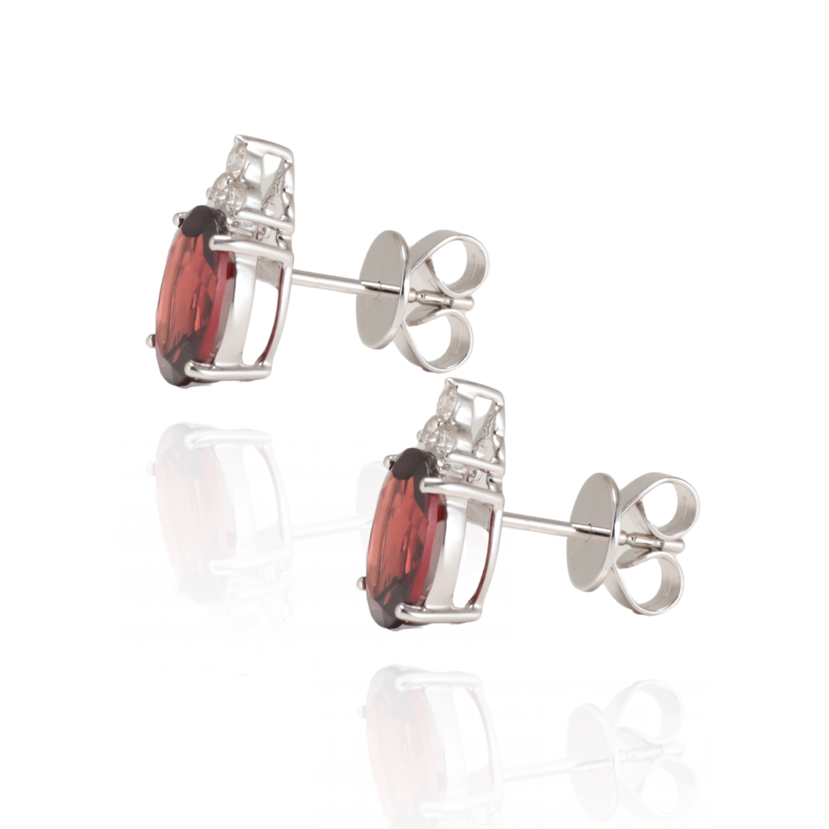 Pair of white gold stud earrings with red Garnet gemstones with natural Diamonds on a white background, side view with butterfly backs. Handcrafted in Sydney, Zappacosta Jewels 