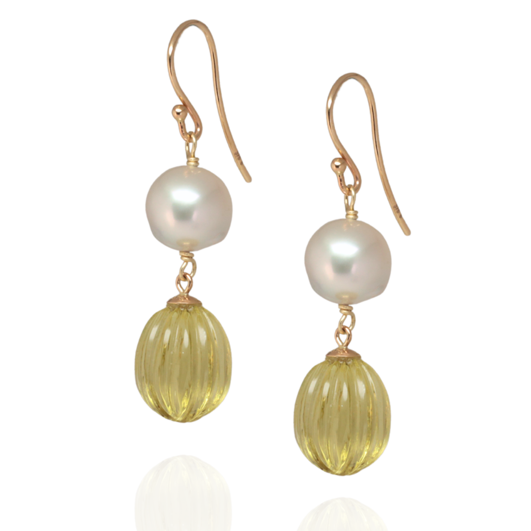 Drop south sea pearl with lemon quartz quartz earrings on a white background 
