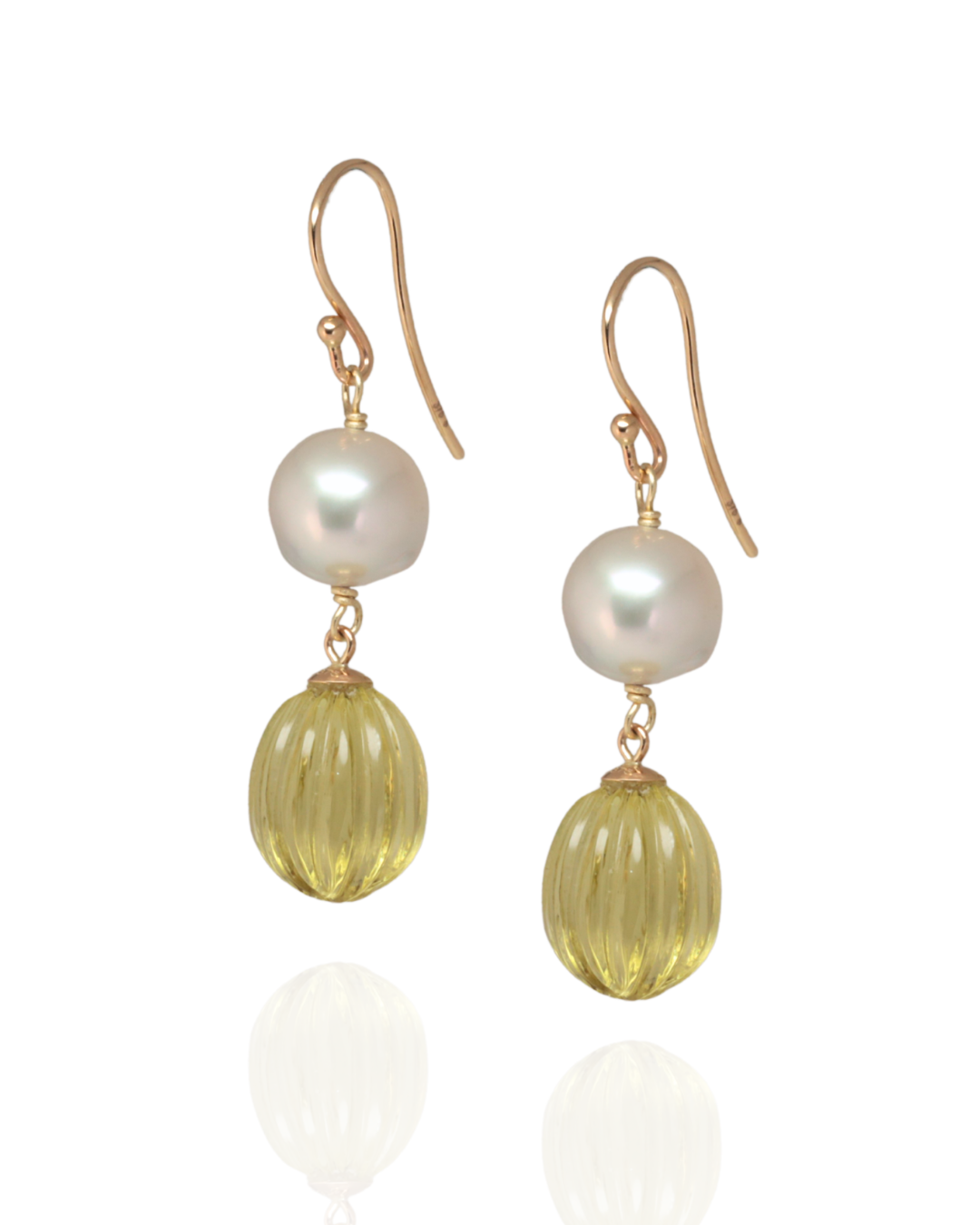 Drop south sea pearl with lemon quartz quartz earrings on a white background 

