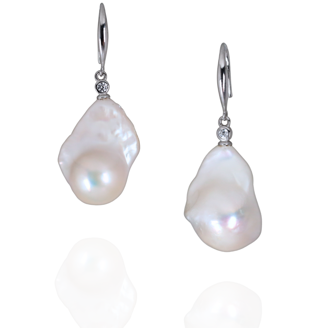 Pair of fresh water baroque earrings with silver hooks on a white background