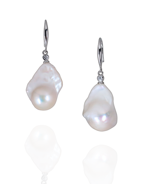 Pair of fresh water baroque earrings with silver hooks on a white background