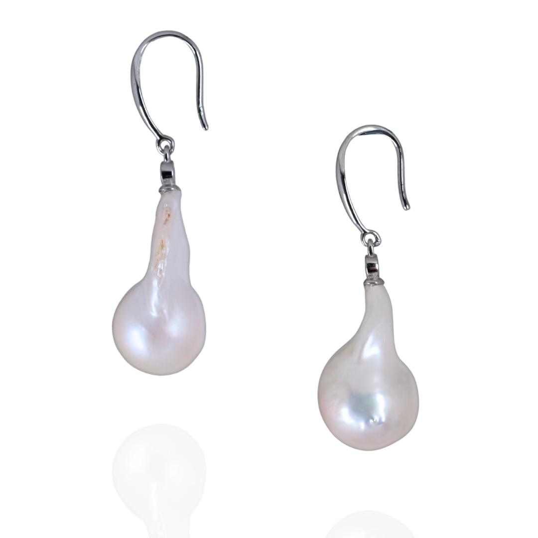 Fresh water baroque pearl earrings with a sterling silver hooks on a white background