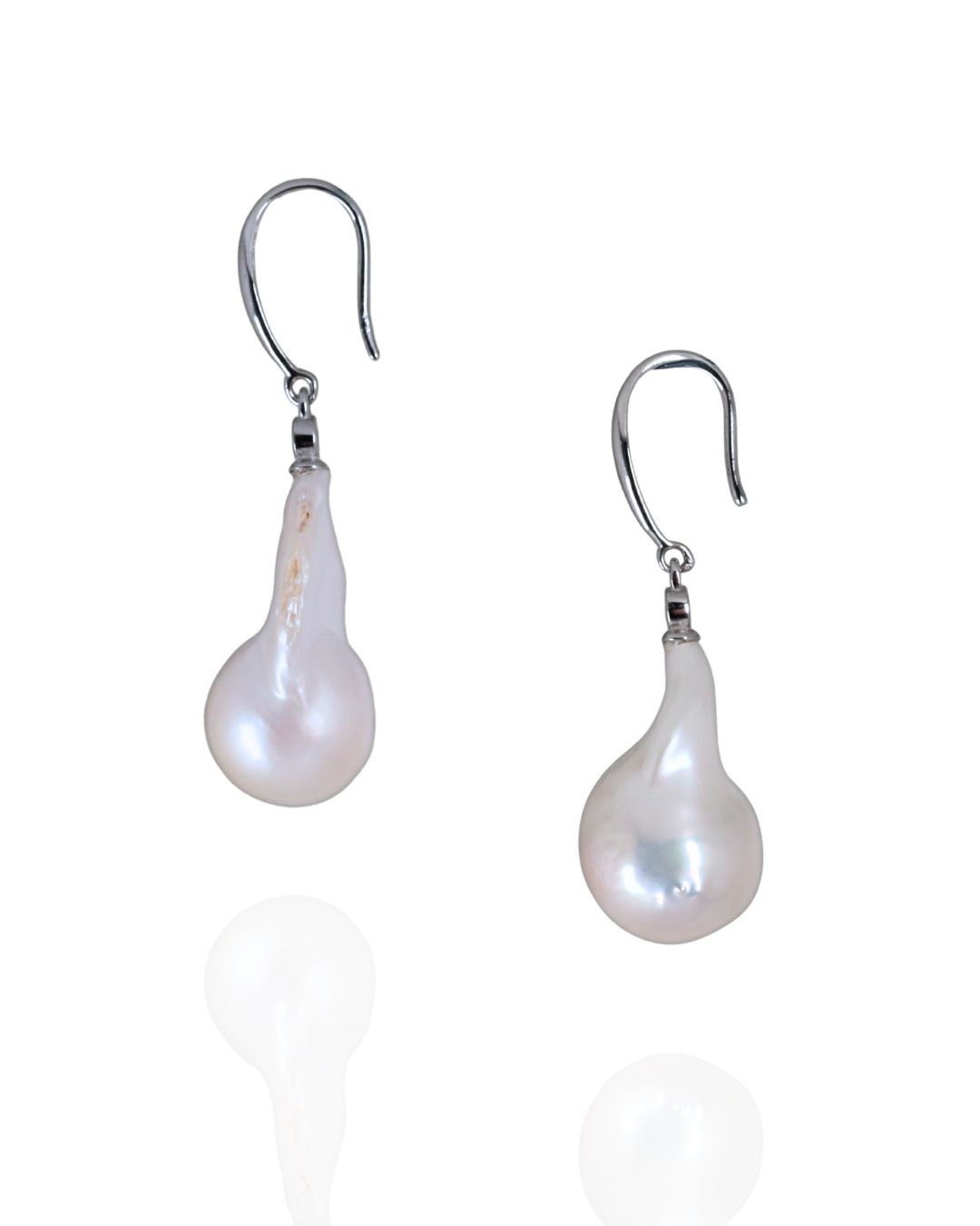 Fresh water baroque pearl earrings with a sterling silver hooks on a white background