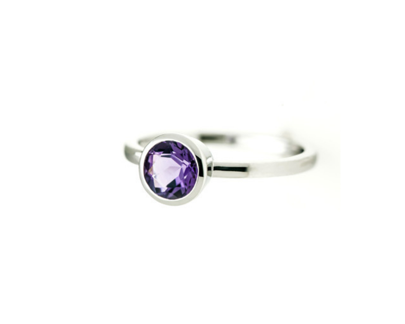 Silver ring with a purple gemstone on a white background