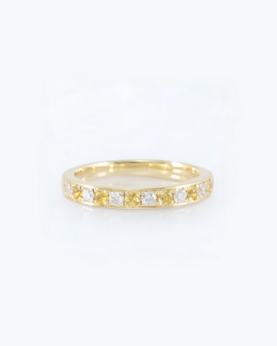 yellow Gold ring with natural sapphires embedded stones on a white background, this is a handcrafted piece by Zappacosta Jewels, Sydney 
